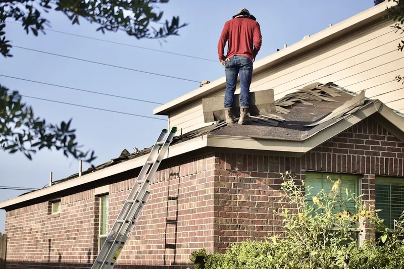 Professional roofer working on a residential roof in Uhlerstown